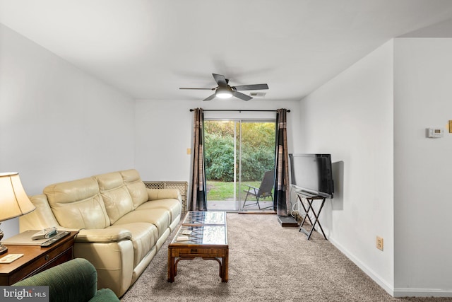 carpeted living room with ceiling fan