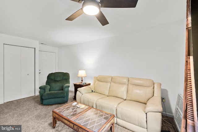 living room featuring carpet and ceiling fan