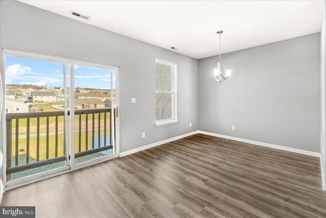 interior space featuring hardwood / wood-style floors and a notable chandelier