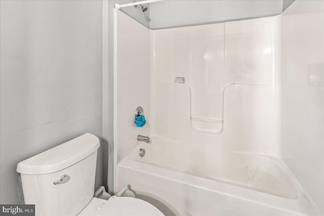 bathroom featuring shower / bathtub combination and toilet