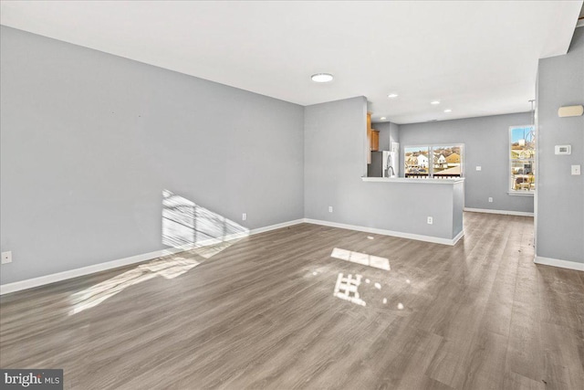 unfurnished living room featuring hardwood / wood-style floors