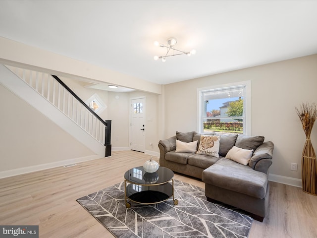 714 W Stephen St, Martinsburg, WV 25401 - living room with light wood finished floors, stairs, visible vents, and baseboards