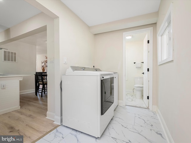 714 W Stephen St, Martinsburg, WV 25401 - clothes washing area featuring baseboards, visible vents, separate washer and dryer, and marble finish floor
