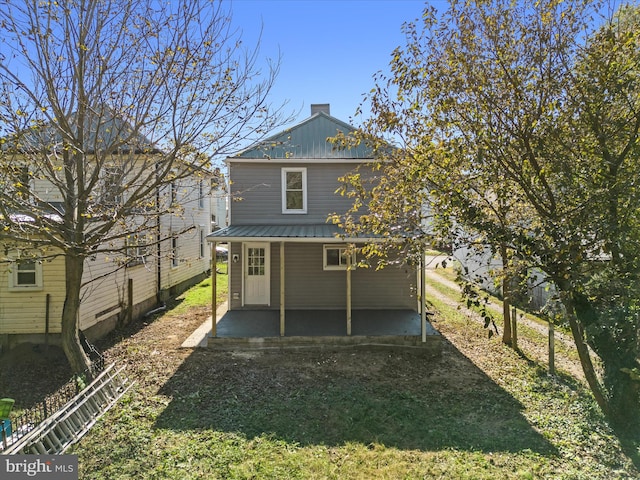 back of property with a patio and a yard