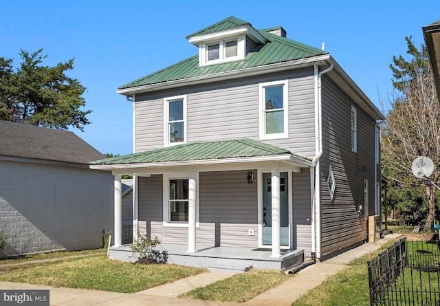 714 W Stephen St, Martinsburg, WV 25401 - american foursquare style home with fence, covered porch, metal roof, and a chimney