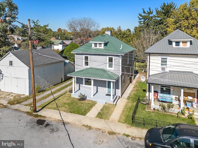 714 W Stephen St, Martinsburg, WV 25401 - american foursquare style home with a chimney, covered porch, fence private yard, metal roof, and a front lawn