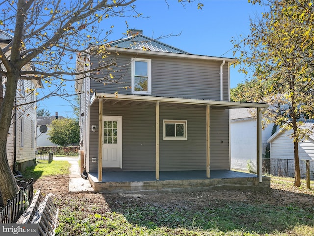 714 W Stephen St, Martinsburg, WV 25401 - rear view of property featuring a porch, metal roof, and fence