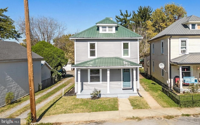 714 W Stephen St, Martinsburg, WV 25401 - traditional style home featuring metal roof, a front lawn, covered porch, and fence