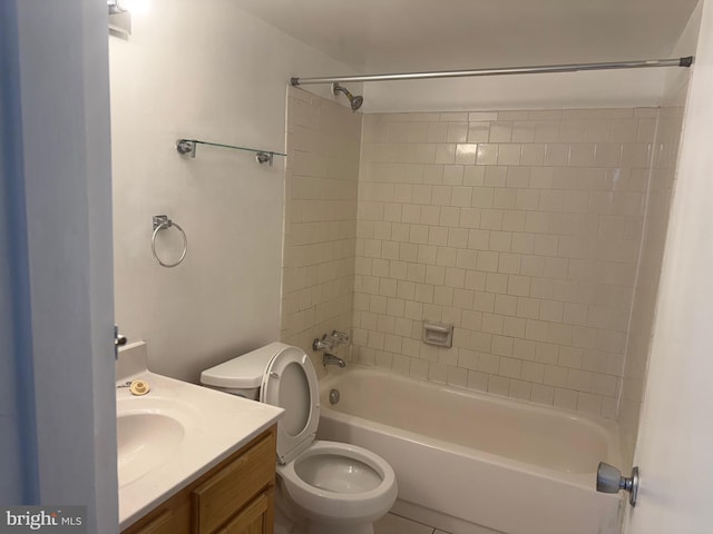 full bathroom with toilet, tiled shower / bath combo, and vanity