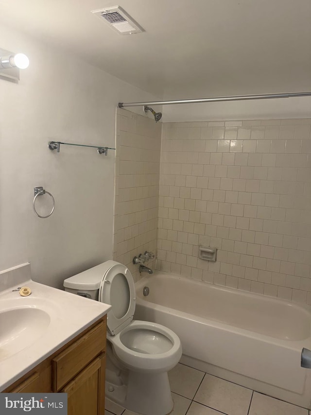 full bathroom with vanity, toilet, tile patterned flooring, and tiled shower / bath