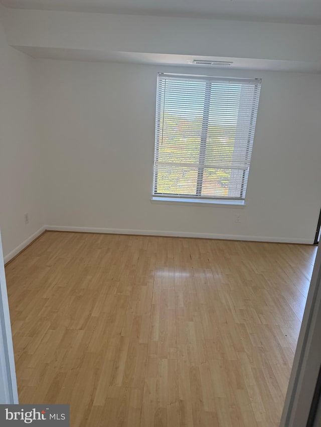 spare room featuring light wood-type flooring