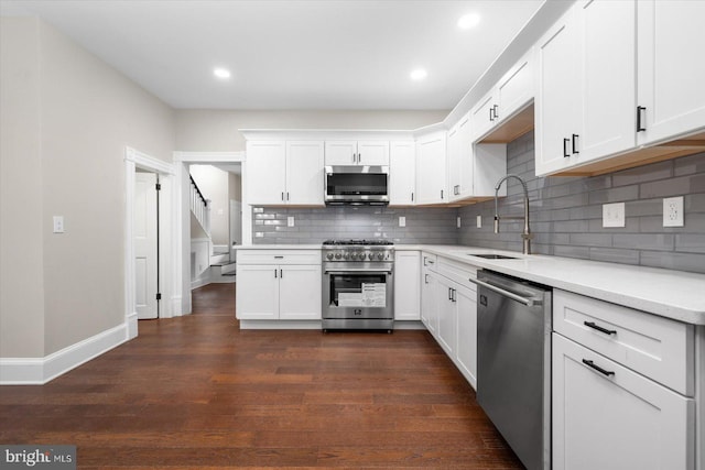 kitchen featuring white cabinetry, appliances with stainless steel finishes, sink, and dark hardwood / wood-style flooring