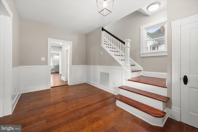 staircase with hardwood / wood-style flooring