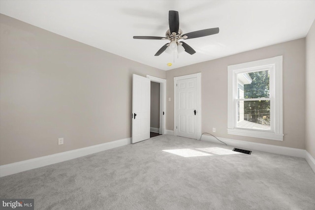 unfurnished bedroom featuring ceiling fan and light colored carpet