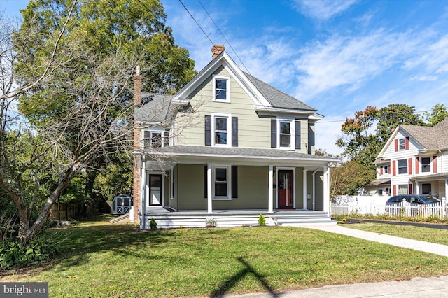 victorian-style house featuring a front lawn and covered porch