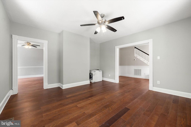 unfurnished living room with dark wood-type flooring and ceiling fan