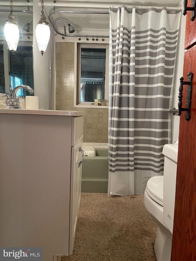 full bathroom with vanity, shower / bath combination with curtain, and toilet