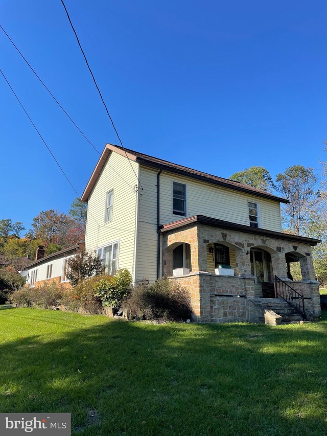 20403 Morgan St SW, Midlothian, MD 21543 - exterior space featuring a yard, stone siding, and covered porch