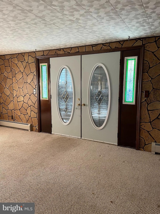 carpeted entryway featuring french doors and a baseboard radiator