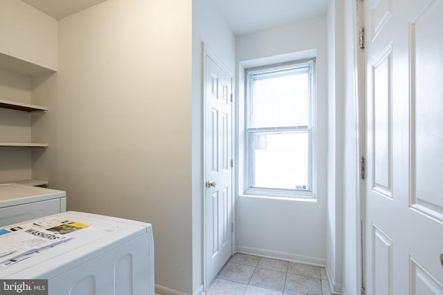 clothes washing area featuring washer / dryer and light tile patterned flooring