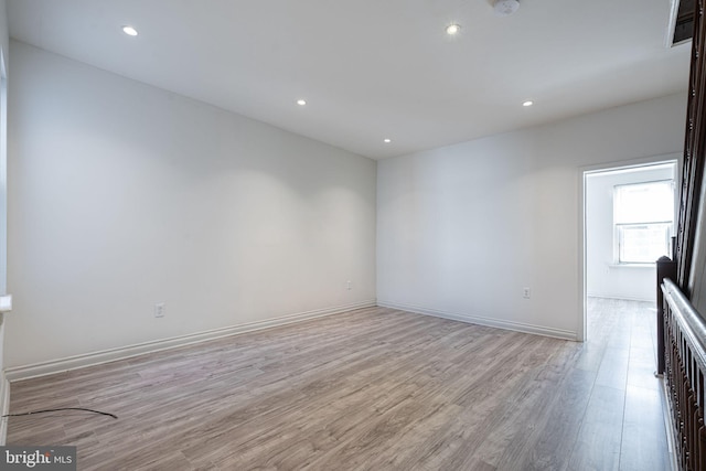 unfurnished room with light wood-type flooring