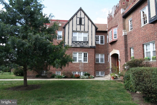 tudor home with a front yard