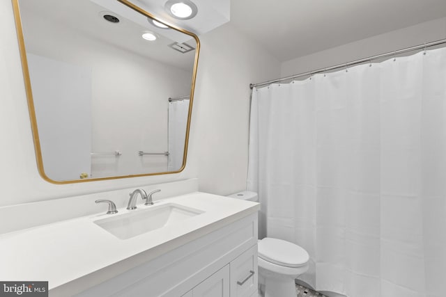 bathroom with vanity, toilet, and walk in shower