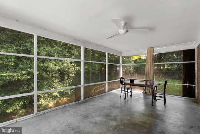 unfurnished sunroom featuring ceiling fan