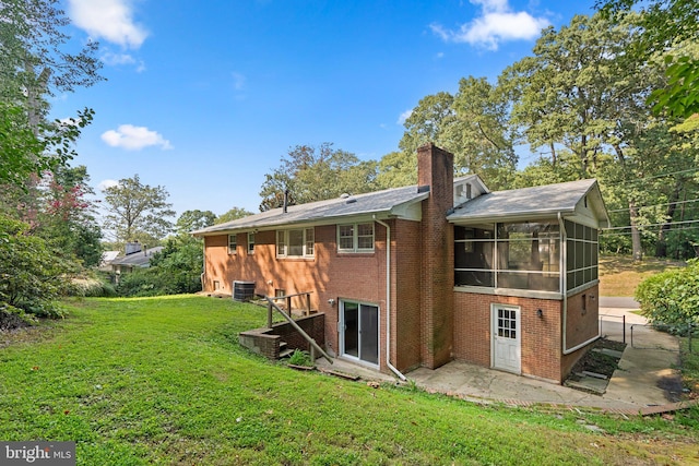 back of house with a patio area, cooling unit, a yard, and a sunroom