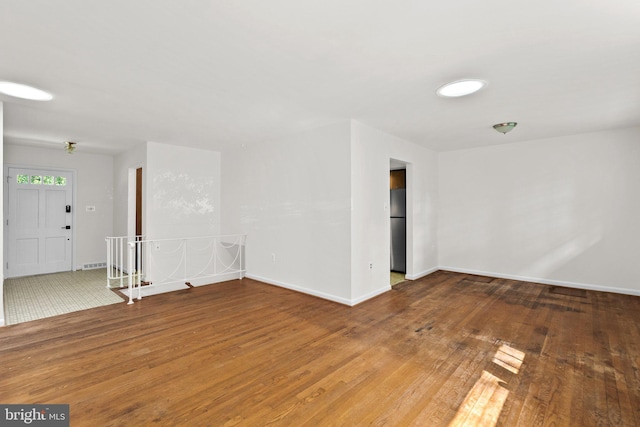 empty room with wood-type flooring