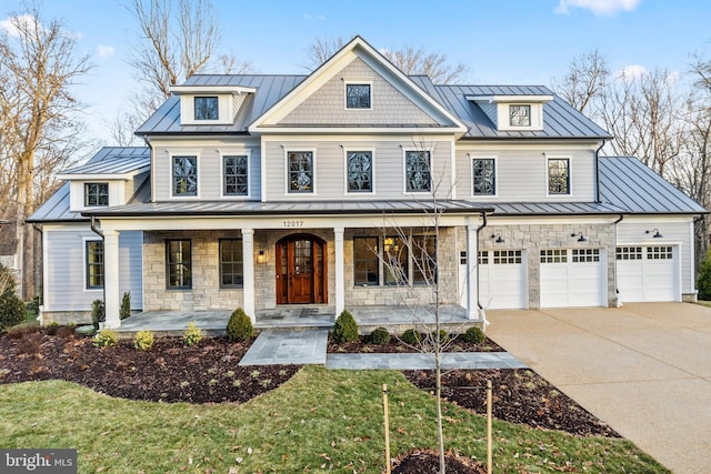 view of front of home featuring stone siding, a porch, a standing seam roof, and metal roof