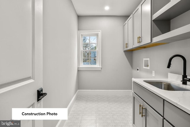 washroom featuring sink, cabinets, washer hookup, electric dryer hookup, and light tile patterned floors