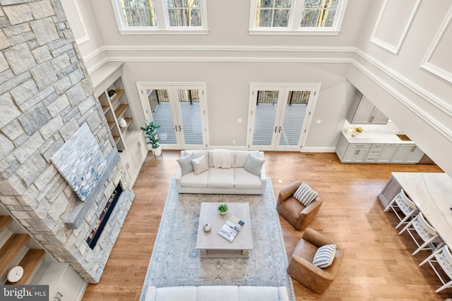 living room featuring french doors, a high ceiling, and hardwood / wood-style flooring