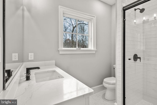 bathroom with tile patterned floors, a shower with door, vanity, and toilet