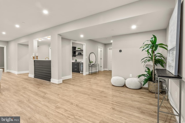 workout room featuring light wood-type flooring