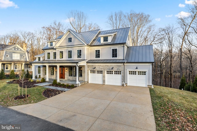 view of front facade with a garage, covered porch, and a front yard