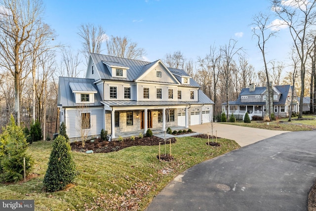 view of front facade with a porch, a garage, and a front lawn