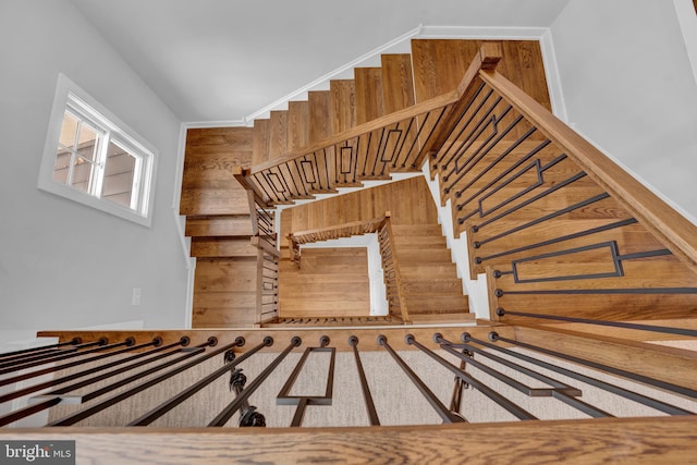 staircase featuring wooden walls