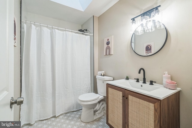 bathroom featuring vanity, curtained shower, toilet, and a skylight