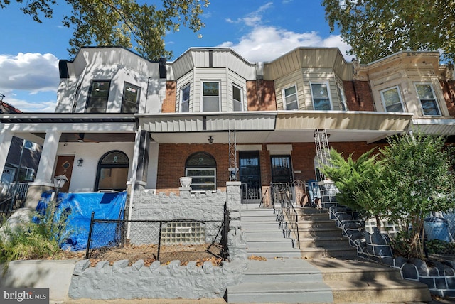 townhome / multi-family property with covered porch