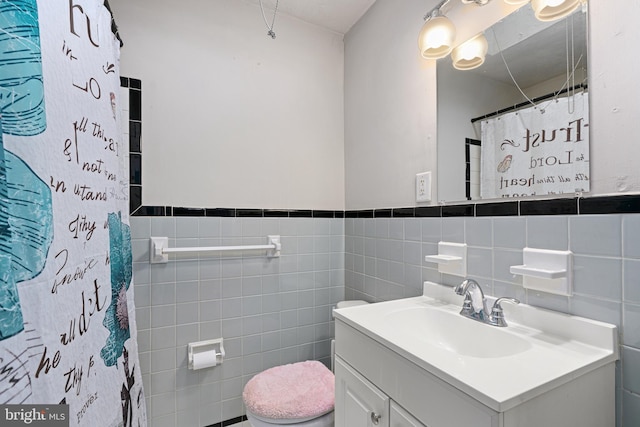 bathroom with vanity, tile walls, curtained shower, and toilet