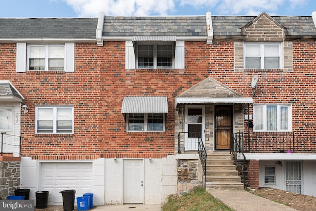 townhome / multi-family property featuring a garage