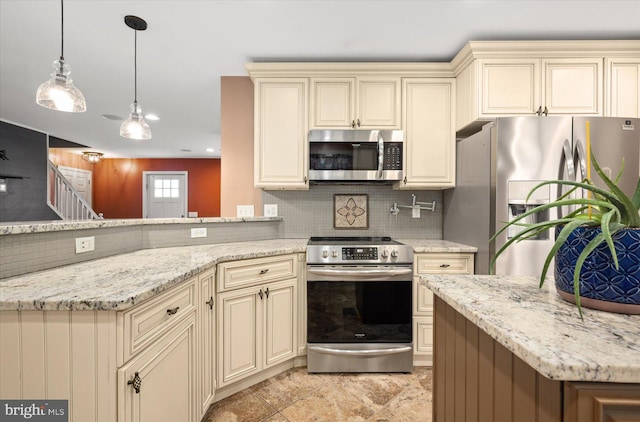 kitchen featuring decorative backsplash, cream cabinets, hanging light fixtures, appliances with stainless steel finishes, and light stone countertops