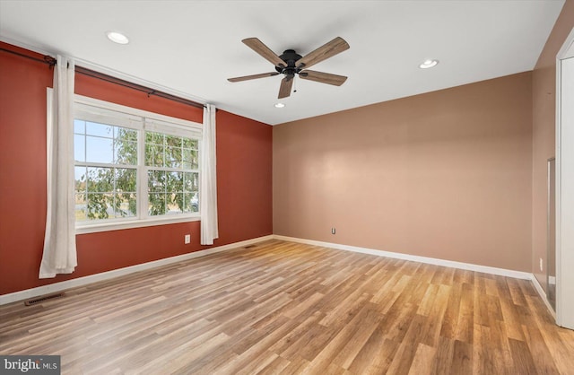 spare room featuring light hardwood / wood-style floors and ceiling fan