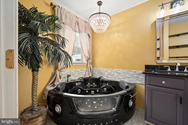 interior space with vanity, a bathtub, and a chandelier