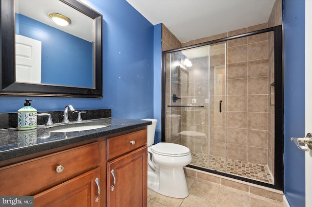 bathroom with vanity, tile patterned floors, toilet, and walk in shower