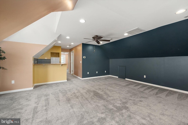 additional living space featuring lofted ceiling, light carpet, and ceiling fan