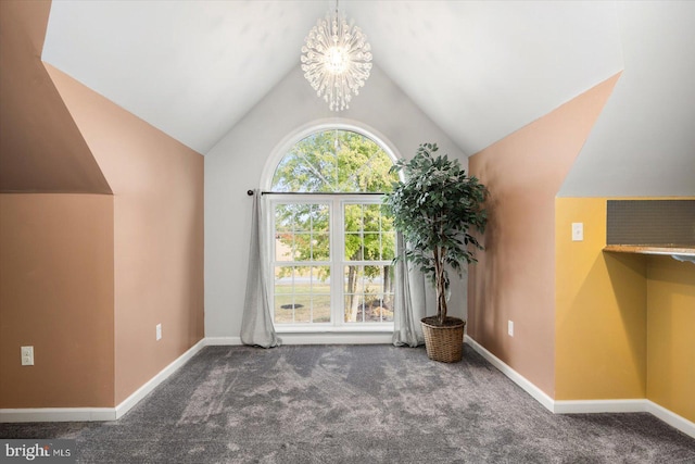 additional living space with an inviting chandelier, dark carpet, and vaulted ceiling