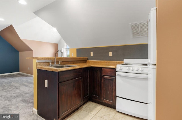 kitchen with white appliances, sink, kitchen peninsula, lofted ceiling, and light colored carpet