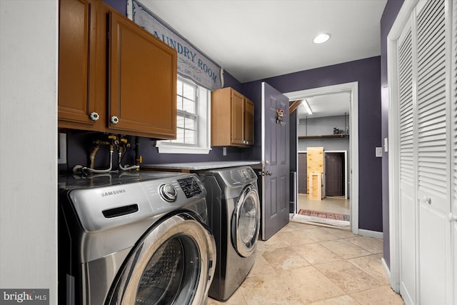 washroom featuring independent washer and dryer and cabinets